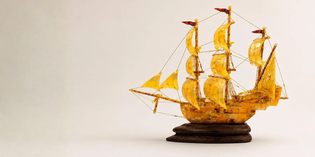 Model ship with yellow sails on a white background